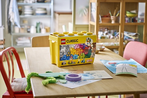 Stavebnice LEGO® Classic ve žluté krabici položené na stole v dětské herně.