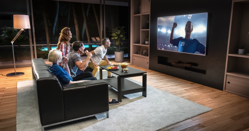 parta lidí sleduje fotbal na velké tv obrazovce