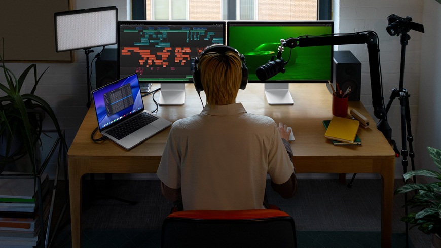 muž sedí u MacBooku a pracuje v Apple Creator Studiu