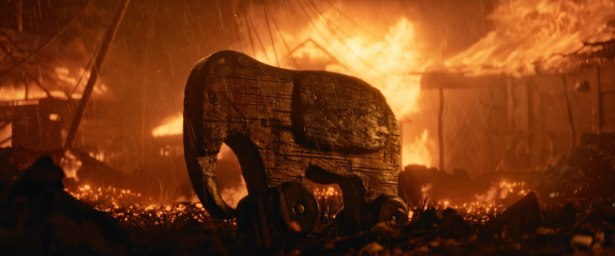 Dřevěný slon na pozadí hořících trosek, screenshot z traileru na Metro 2039