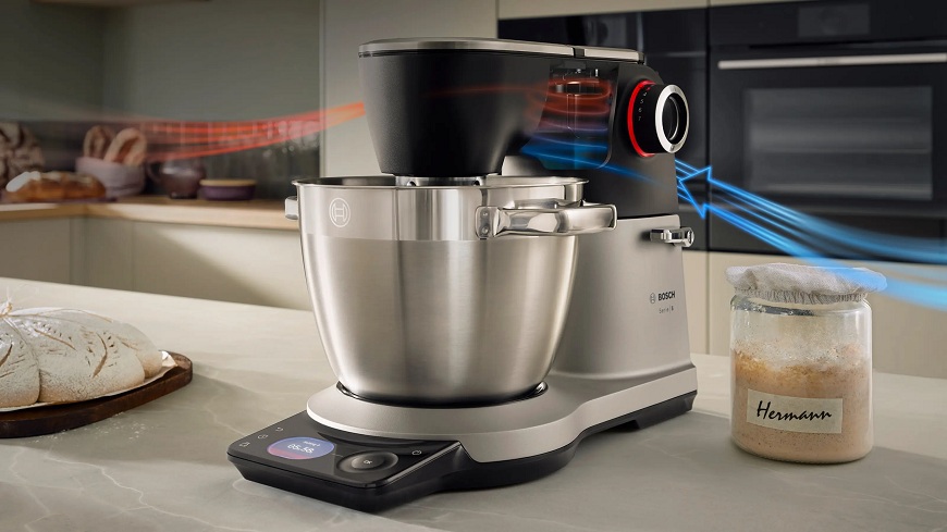 Moderní kuchyňský robot Bosch Serie 8 v nerezovém a černém provedení na kuchyňské lince. Obrázek zná