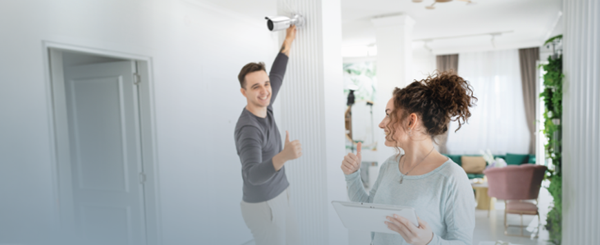 HiLook Smart Hybrid Light: Barevné noční vidění pro domácnosti i firmy Muž instaluje kameru HiLook a usmívá se na žena. Ukazují si palce nahoru.