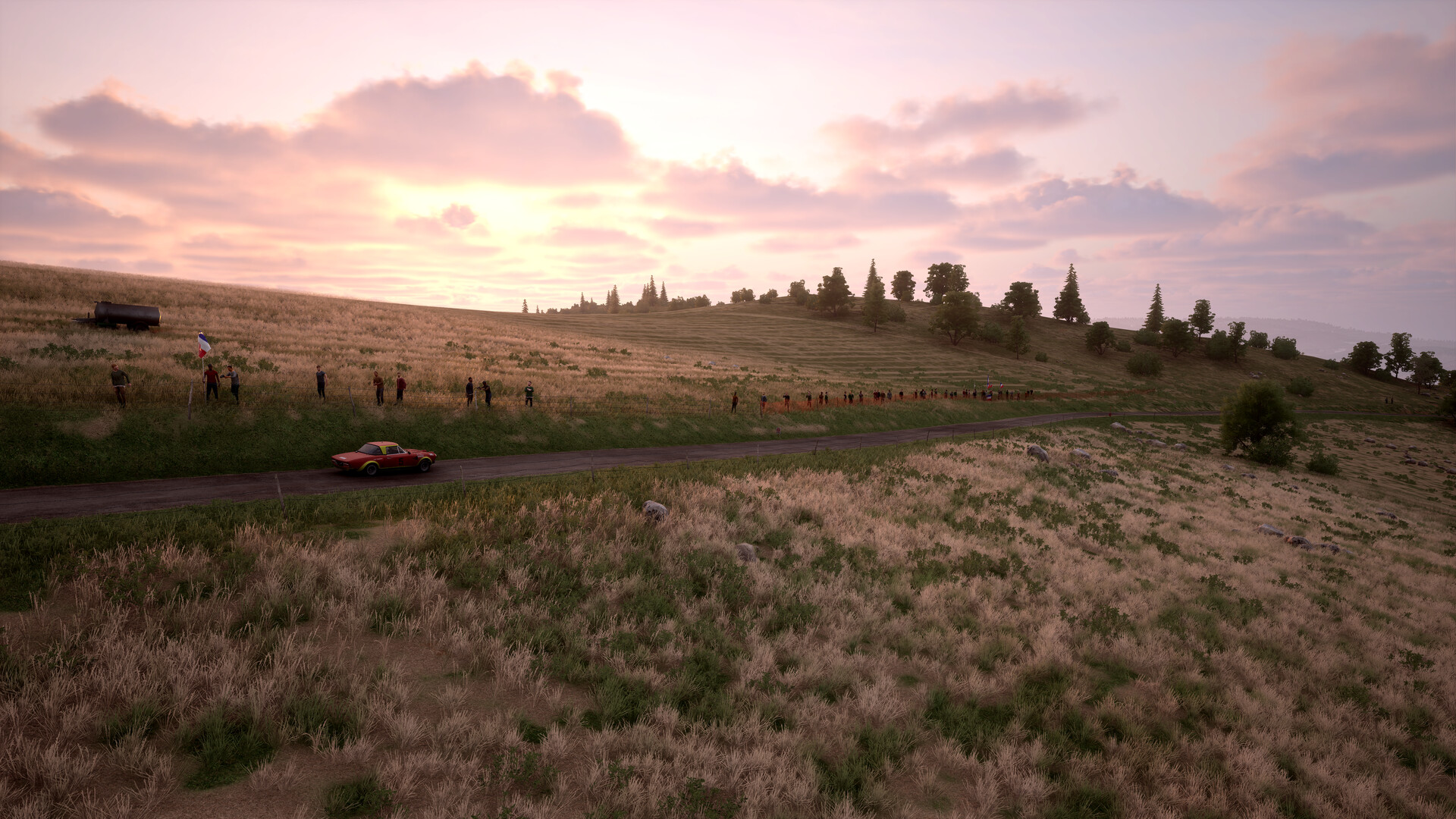 Assetto Corsa Rally: Šampion v simracingovém realismu Krajina ozářená zapadajícím sluncem, po silnici jede závodní auto
