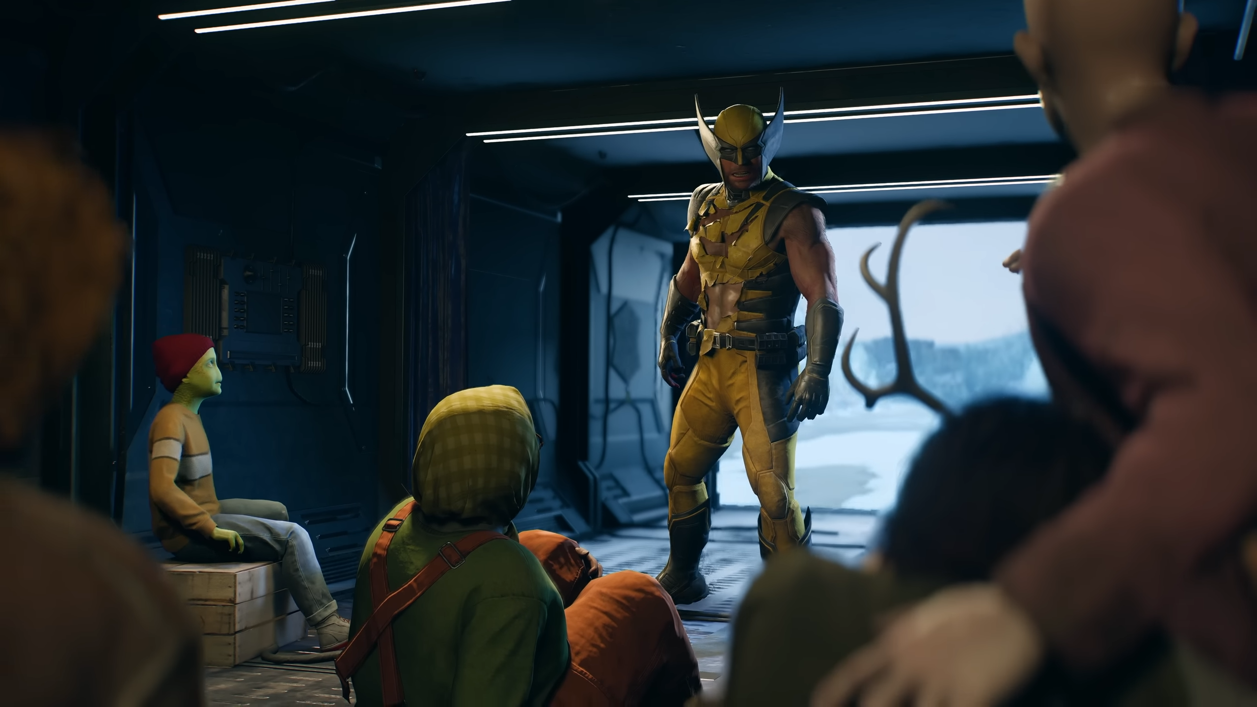 Wolverine stojí v otevřeném nákladním prostoru auta, před ním sedí několik mutantů