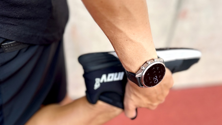 Chytré hodinky Garmin fēnix® 9 Pro v detailu na zápěstí muže, který se protahuje před během