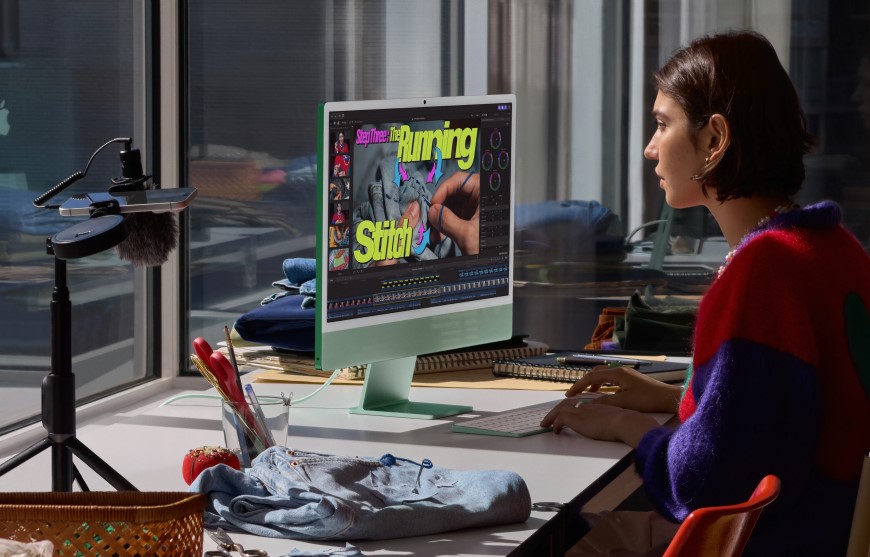 Zapomeňte na dýně, Halloweenský týden pokračuje úrodou „jablečných“ novinek – Apple odhalil nový iMac a MacBook Pro se supervýkonnými čipy M6! Žena pracující v kanceláři na all-in-one počítači iMac M6 v zeleném provedení